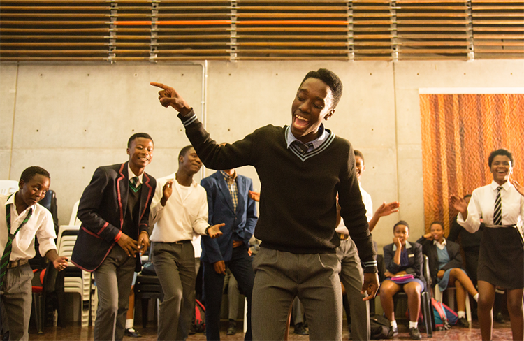 A young teenager singing at an Ubuntu performance centre